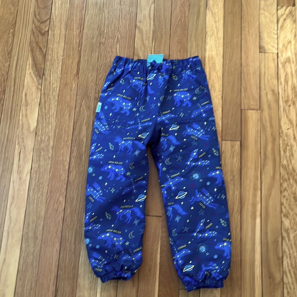 Kids waterproof snow pants with a cute astrological pattern.